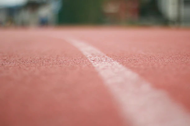 Close-up of a runner's feet pounding the track during a race.