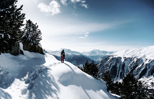 person walking on snowy mountain during daytime in Aletsch Glacier Switzerland