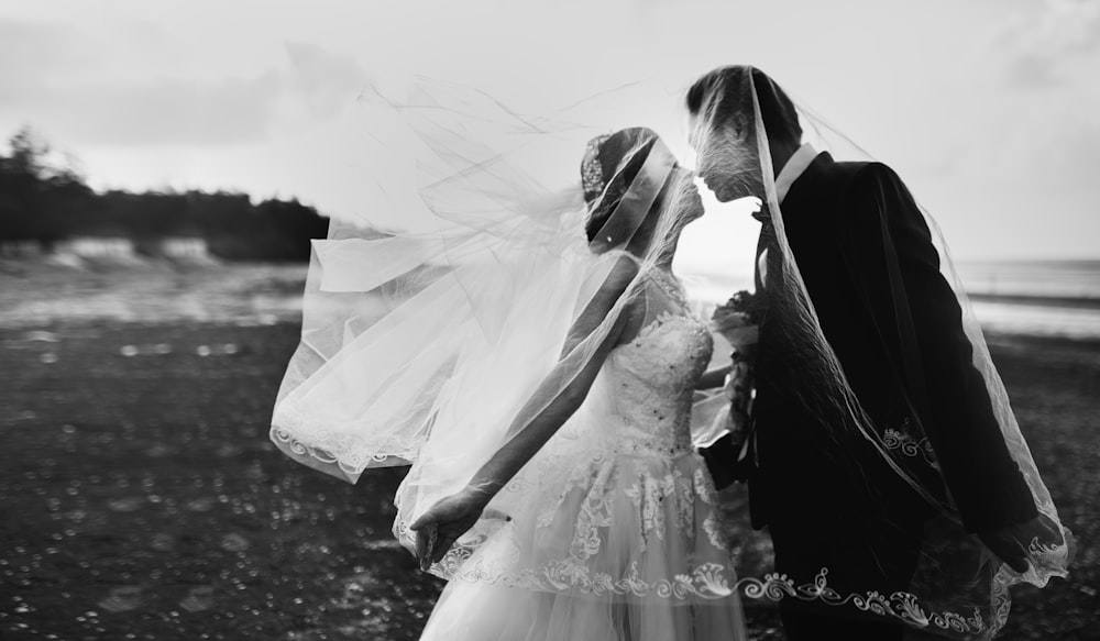 grayscale shot of bride and groom