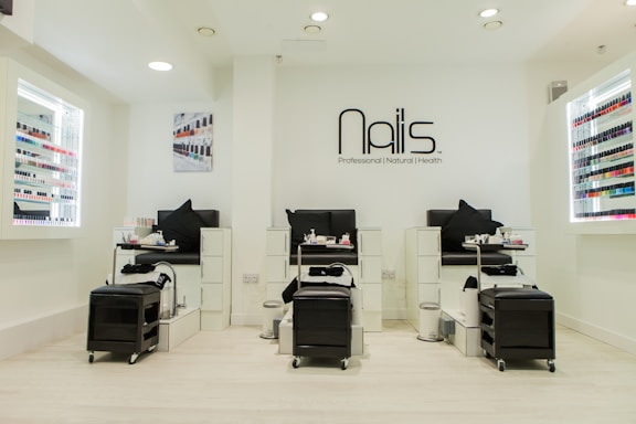 A cozy and stylish hair salon interior with manicure and pedicure stations.