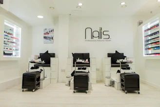 A sleek, minimal login panel with soft pink and white tones reflecting a cozy nail salon atmosphere.