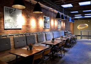 Chic dining area showcasing a custom table and artistic lighting fixtures