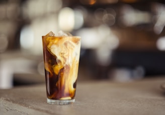 glass cup filled with ice latte on tabletop