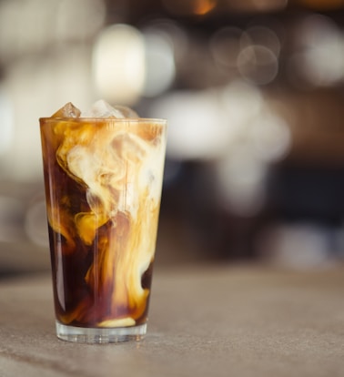 glass cup filled with ice latte on tabletop