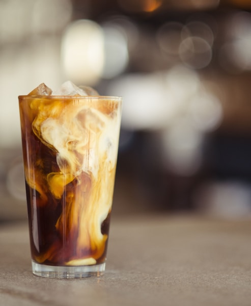 glass cup filled with ice latte on tabletop