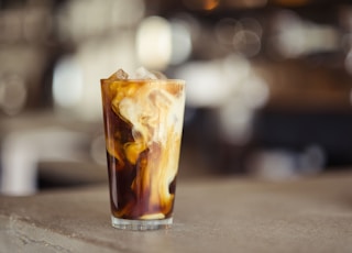 glass cup filled with ice latte on tabletop