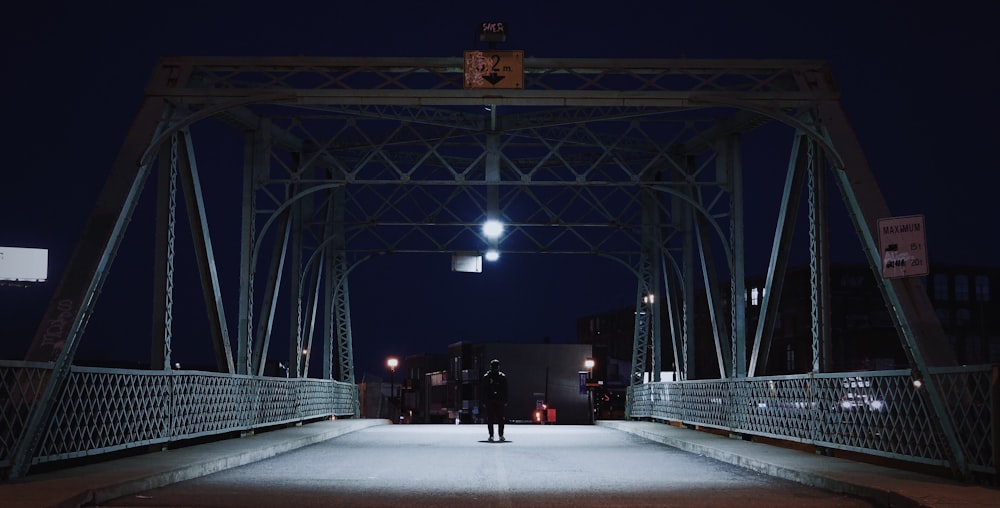 silhouette of man on bridge