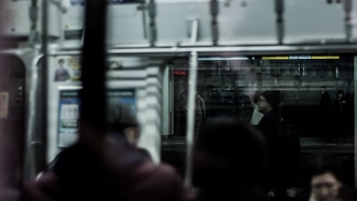 A crowded subway car where faces blur into a mosaic of silent stories and hidden thoughts.