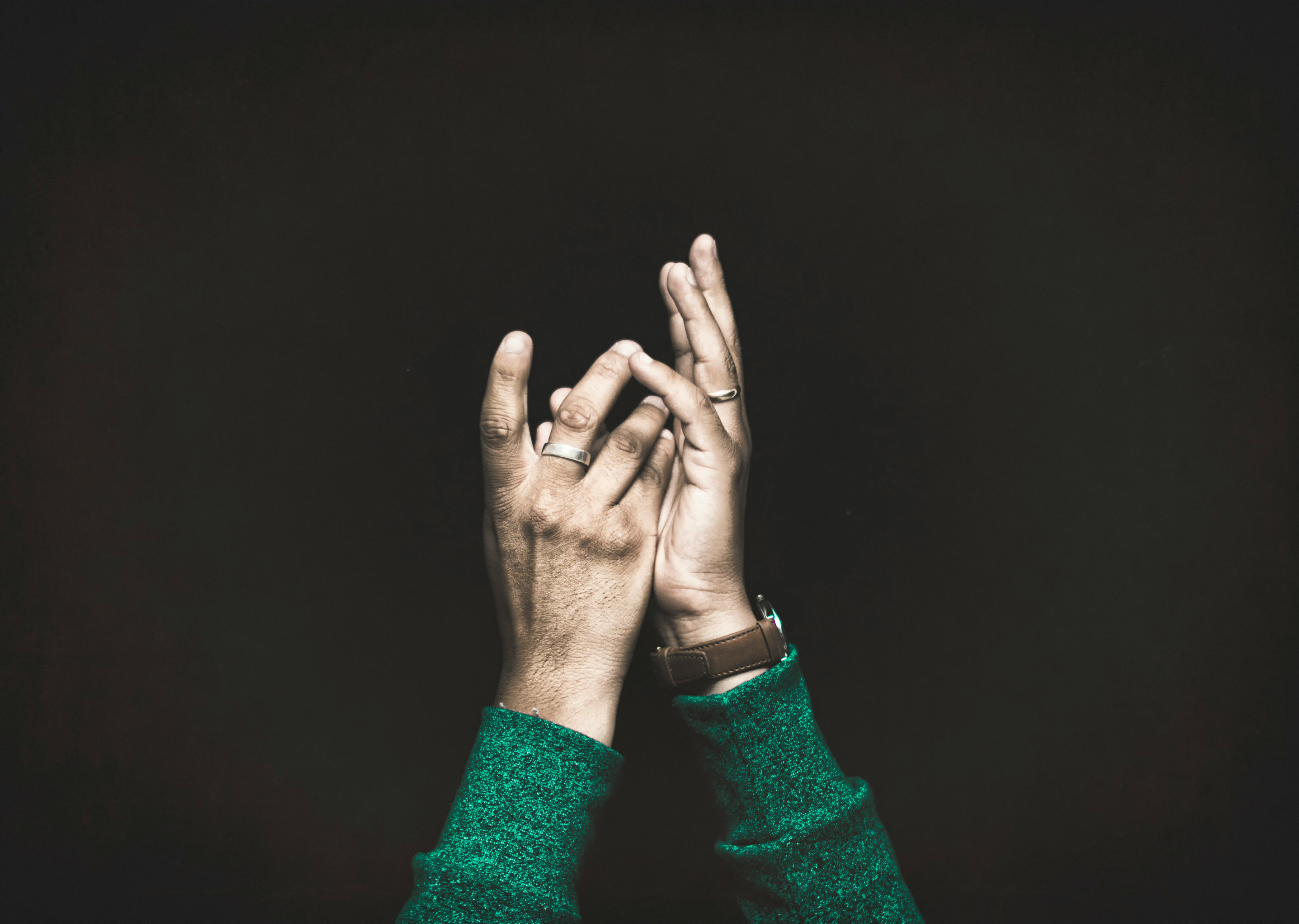 closeup photo of person raising both arms