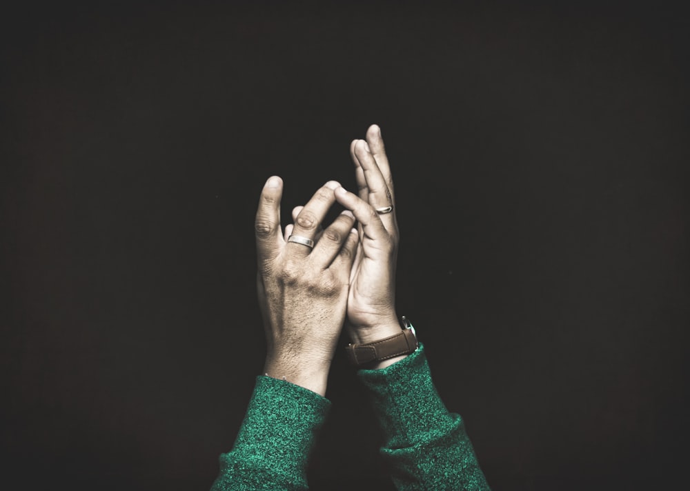 closeup photo of person raising both arms