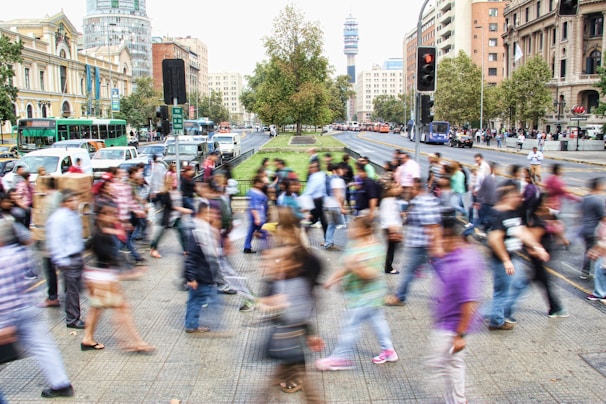 A busy New York City street with people walking and buildings in the background.