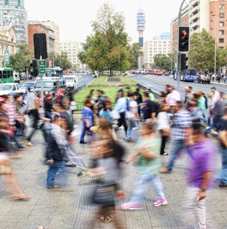 timelapse photo of people passing the street