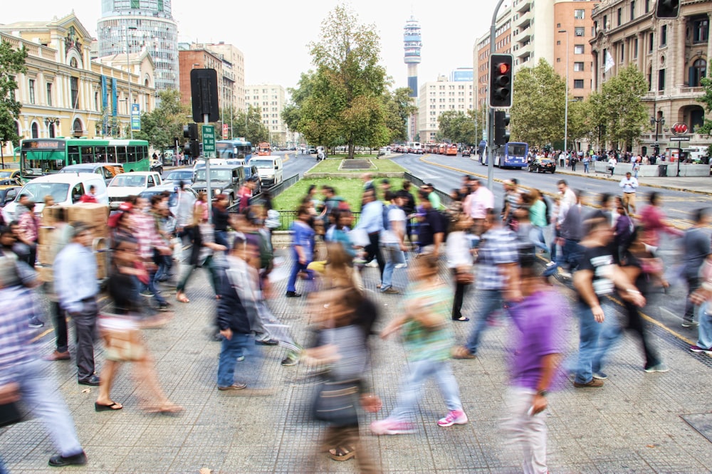 timelapse photo of people passing the street