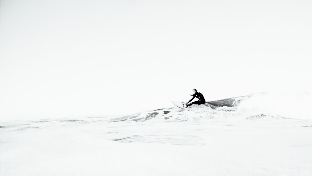 grayscale photography of person surfing