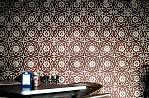 a room with a table and a wall with a pattern on it