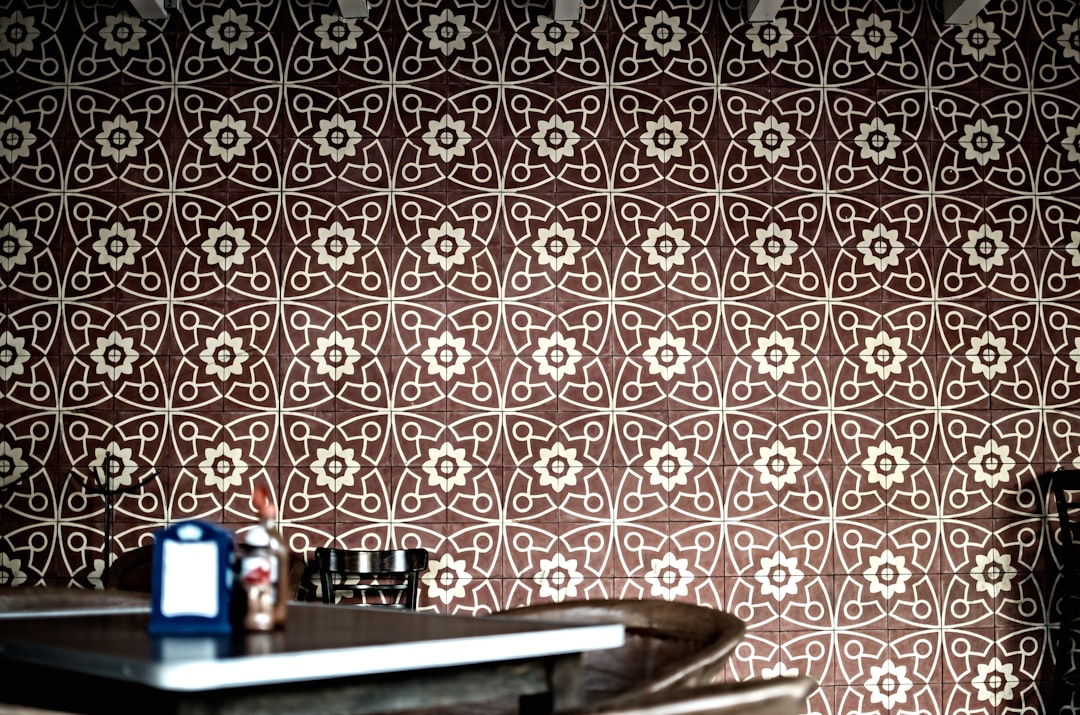 a room with a table and a wall with a pattern on it,