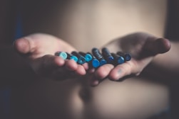 person holding blue crayons
