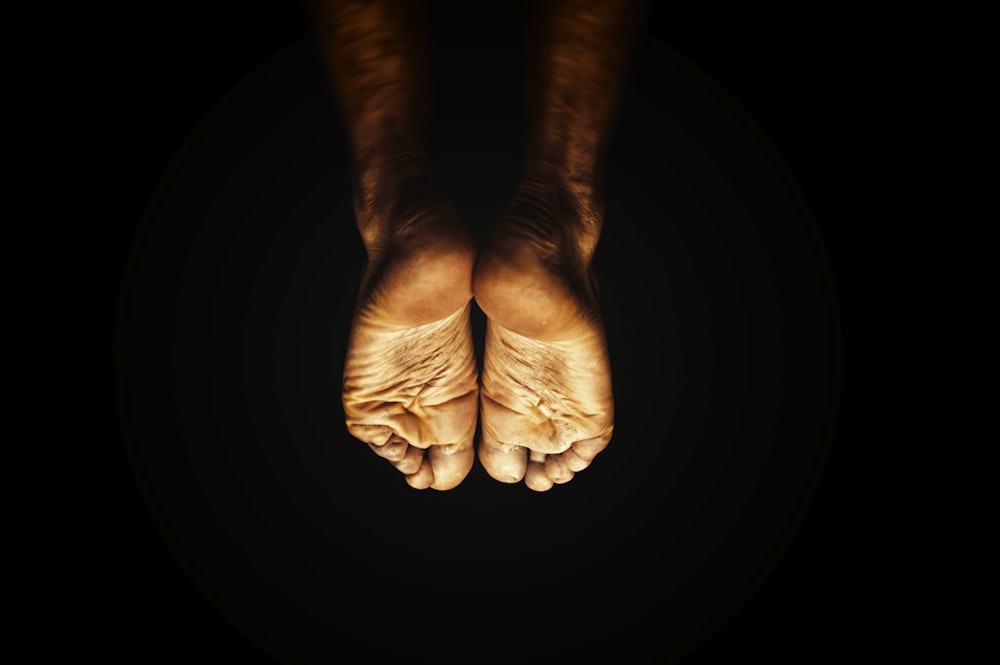 persons feet on black background