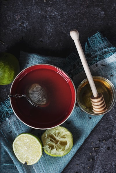 tea blend steeping in basket with honey