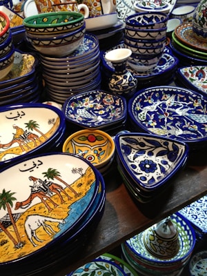 Delicate pottery pieces painted with classic Indian motifs in earthy tones.