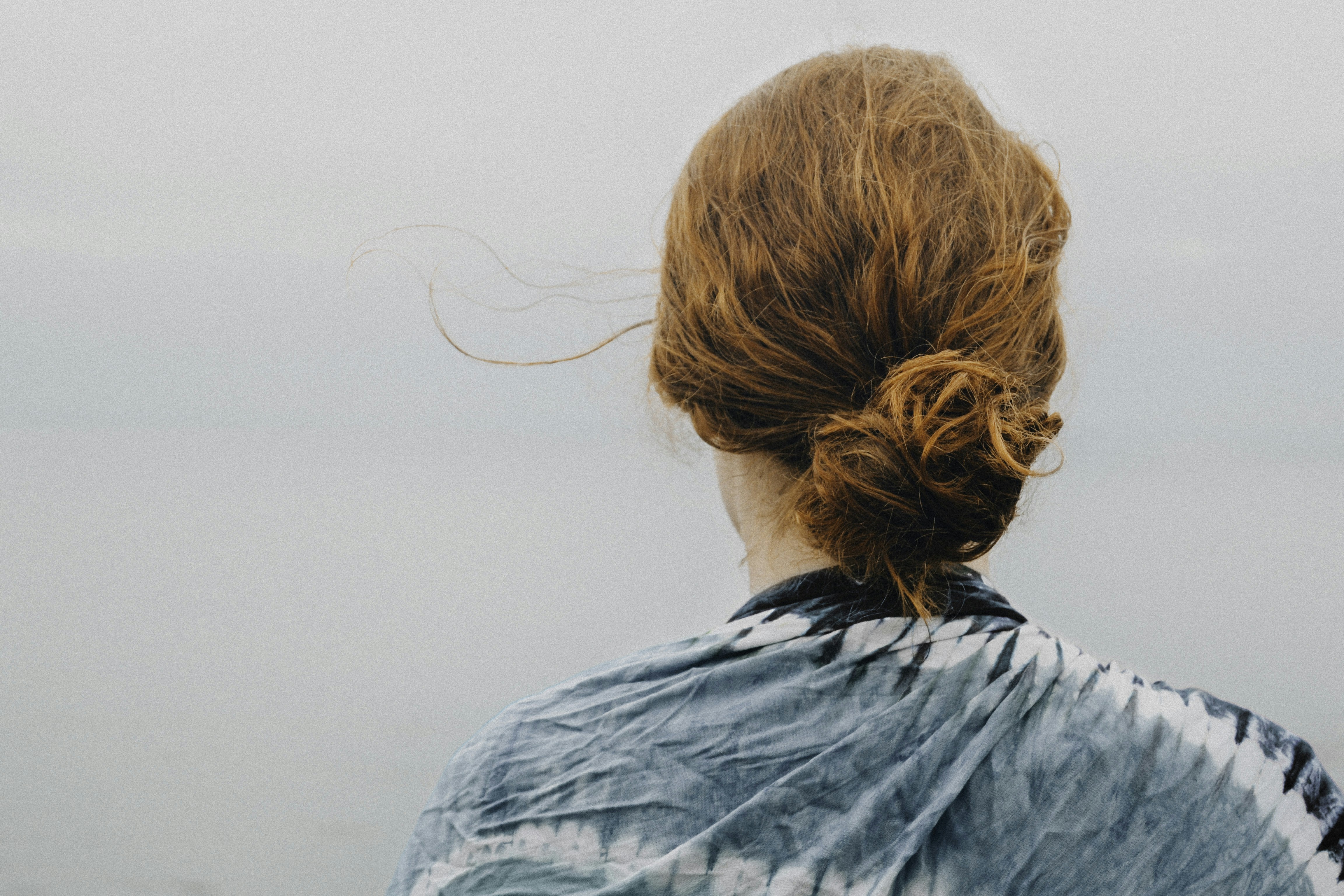 Woman red hair looking at sky