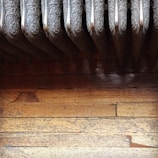 A technician replacing a radiator in a cozy room.