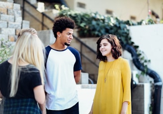 women and man talking outside the building