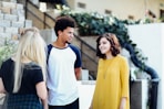 women and man talking outside the building