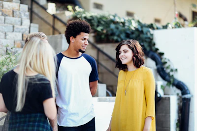 women and man talking outside the building