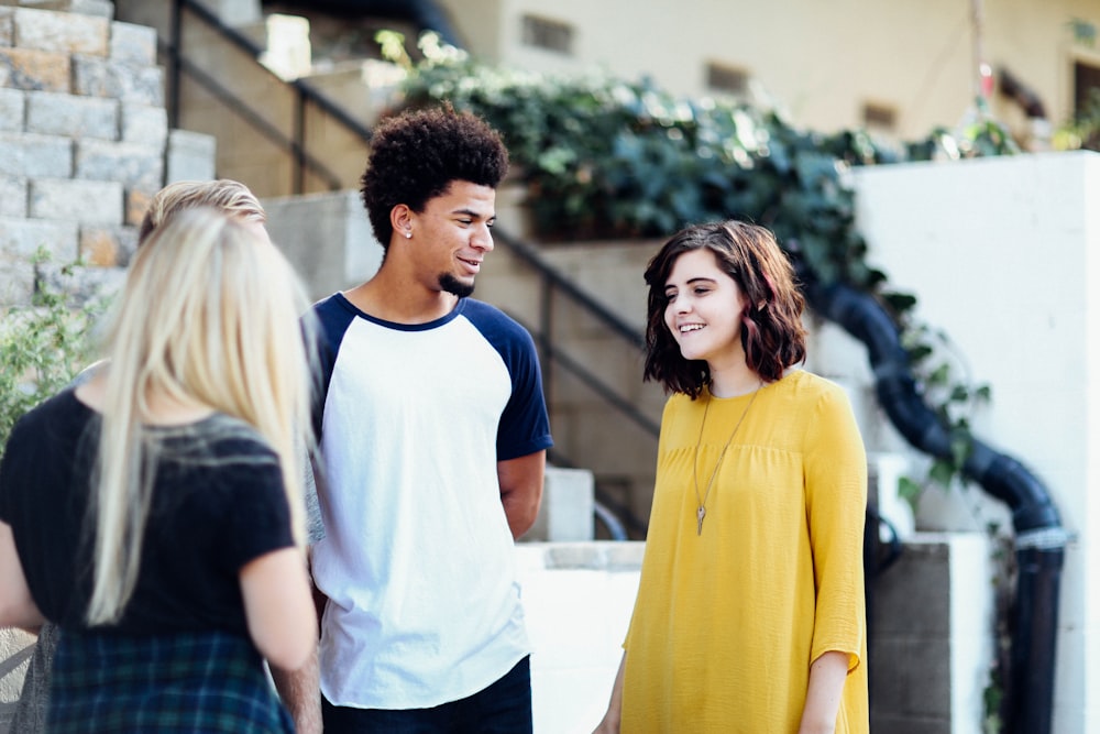 women and man talking outside the building