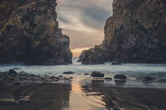 river overflow in between rock formation in Pfeiffer Beach United States