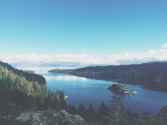 lake surround by mountains and trees under blue sky in Emerald Bay State Park United States