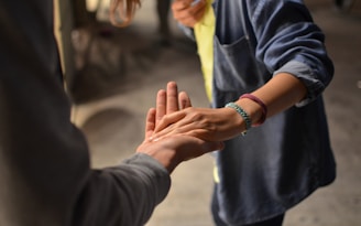 man and woman holding hands on street