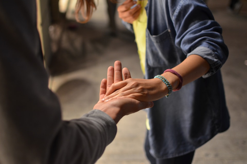 “Close-up of hands offering support, symbolizing compassion, connection, and community service.”