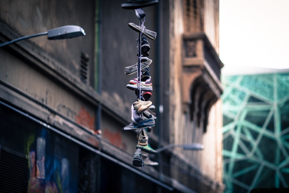 string of shoes hanging on streetlight