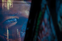 Close-up of Reboiras' brush strokes on a colorful mural wall.