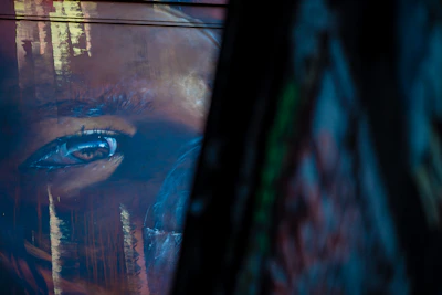 Close-up of Reboiras' brush strokes on a colorful mural wall.