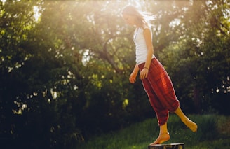 woman standing on wood log