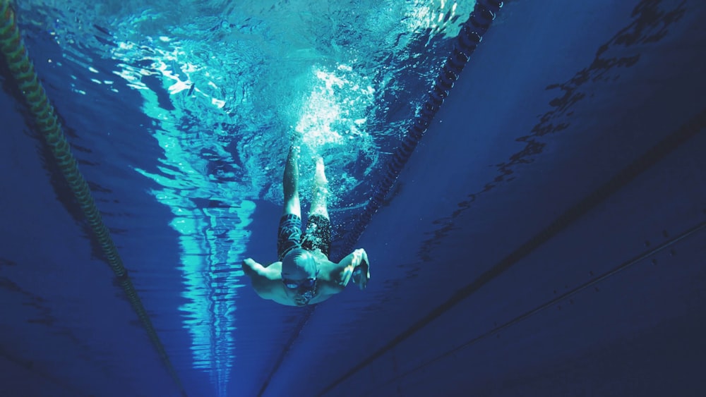 man swimming in swimming pool