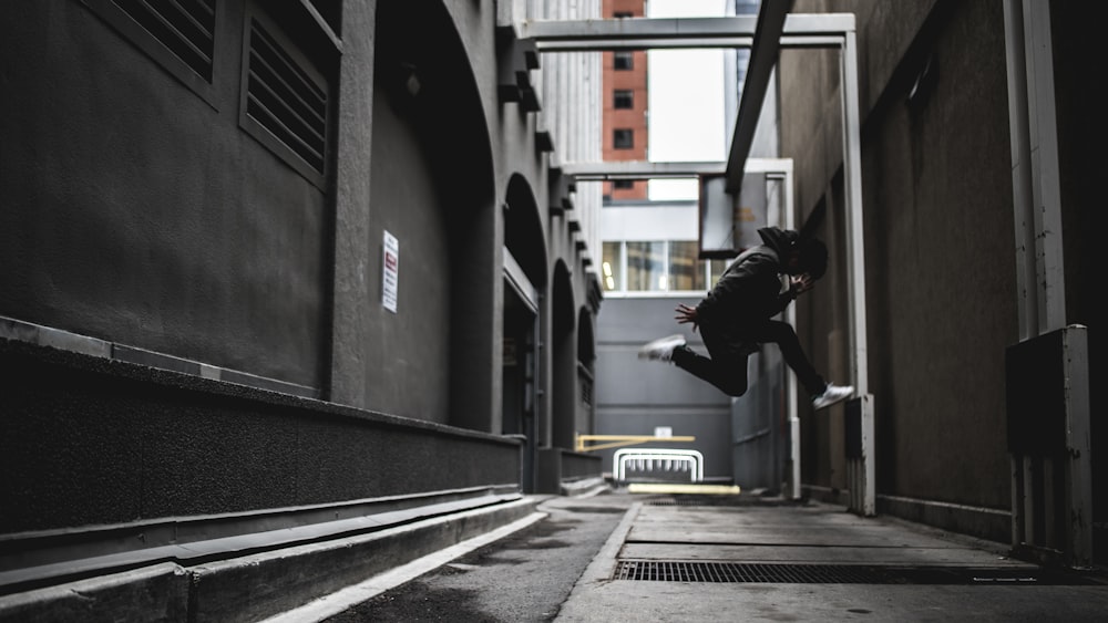 person wearing black pants and white shoes jumpshot