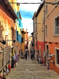 A vibrant street in Malta lined with diverse local shops and cafes.
