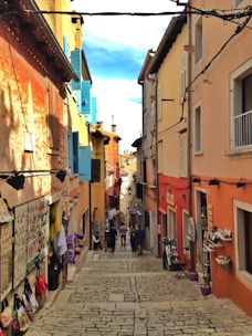 A vibrant street in Malta lined with diverse local shops and cafes.