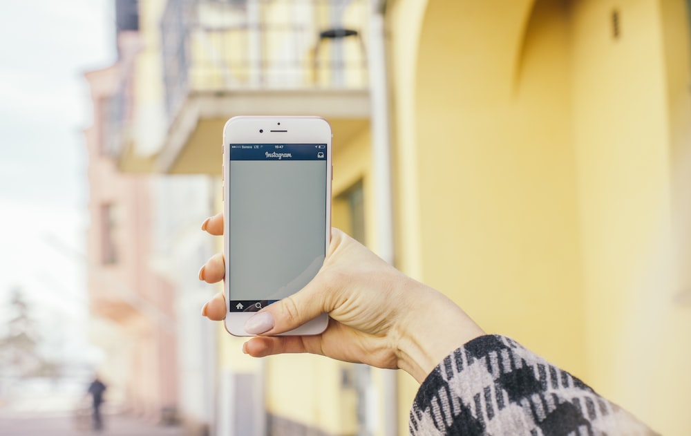 person holding gold iPhone 6