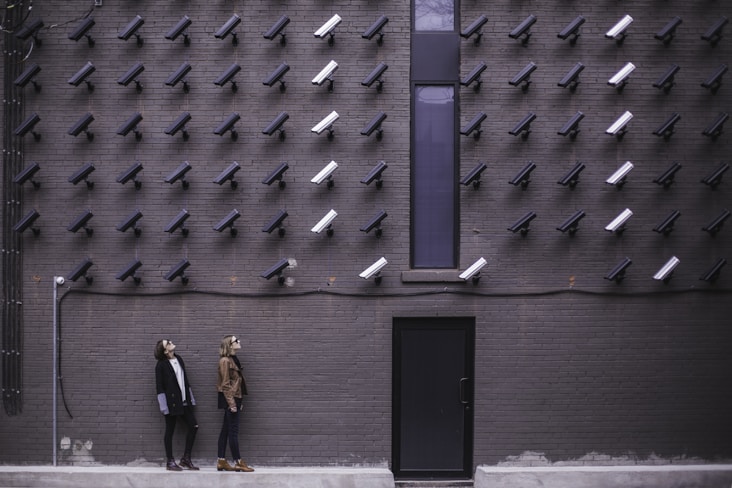 Two individuals observed by multiple surveillance cameras, highlighting privacy challenges