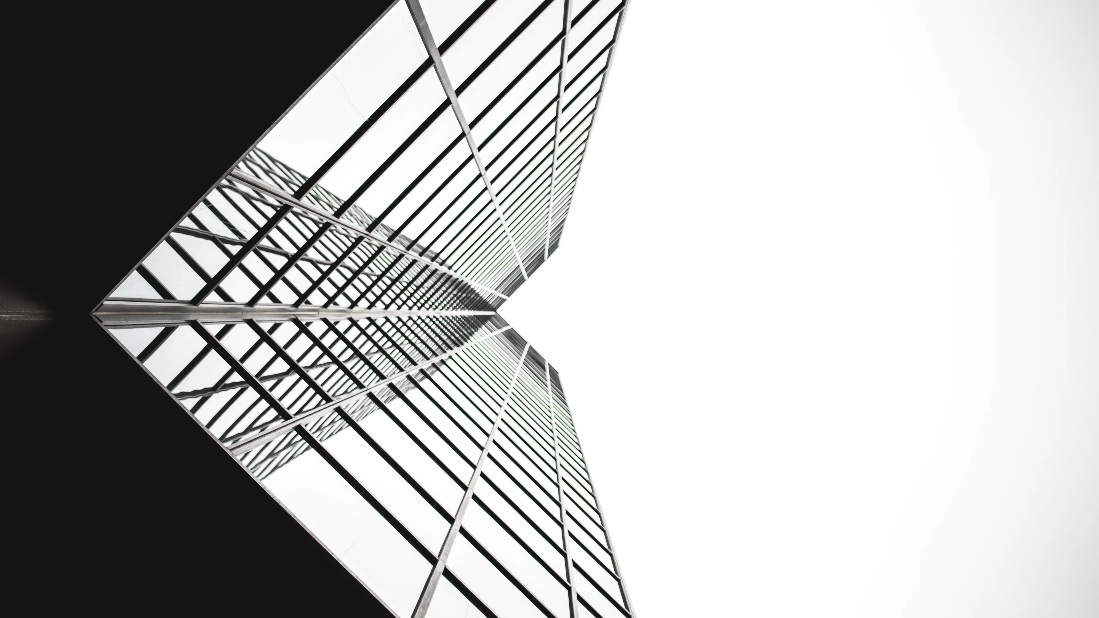 Upward view of a modern mirror-glass office tower