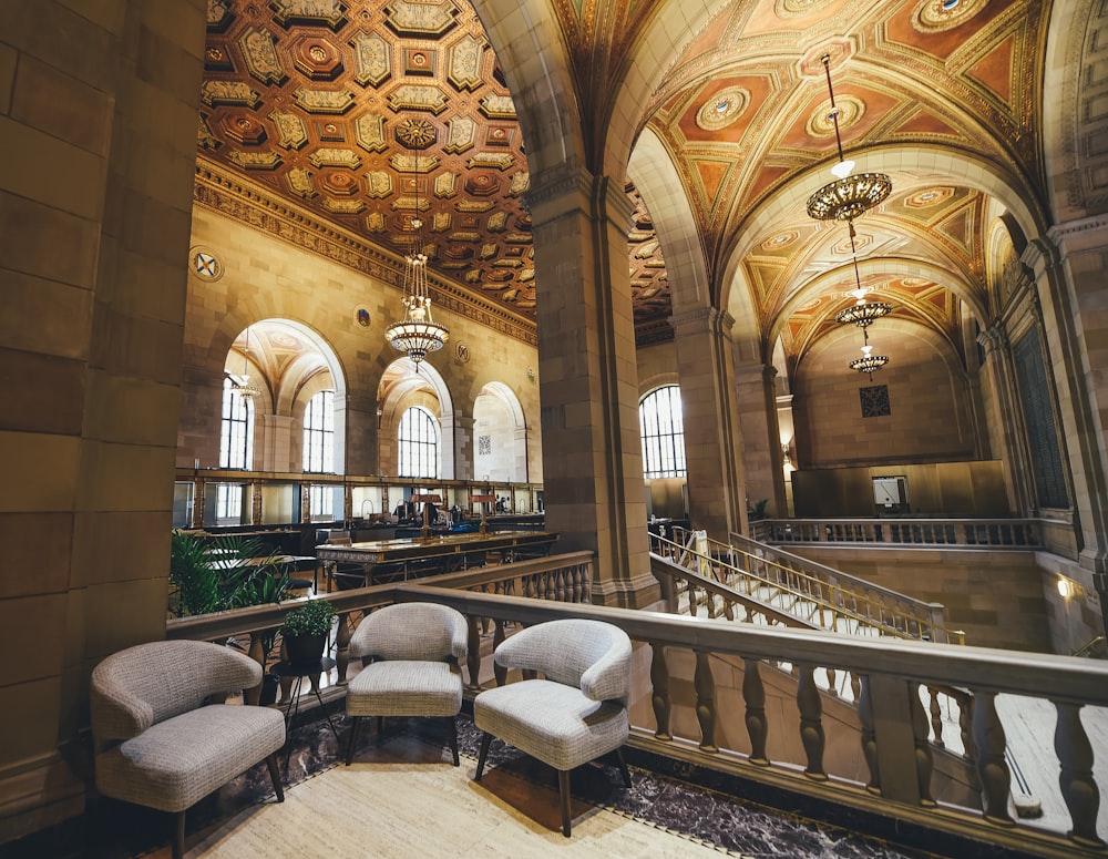 three fabric chairs near balustrade