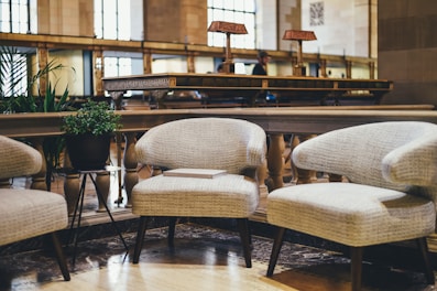 Small seating area with a coffee table and armchair near a window.