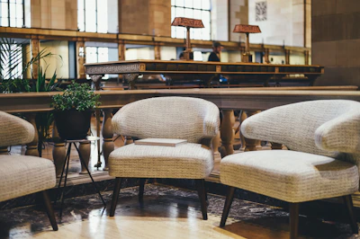 Inviting seating area with plush chairs and a small coffee table in a guest room.