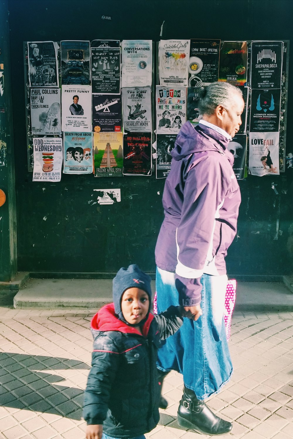 woman standing beside toddler