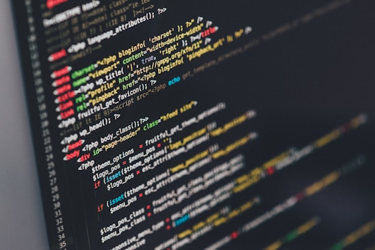 A computer screen displaying code written in PHP and HTML with various lines of syntax highlighted in different colors. The text includes commands, tags, and functions typical for web development.